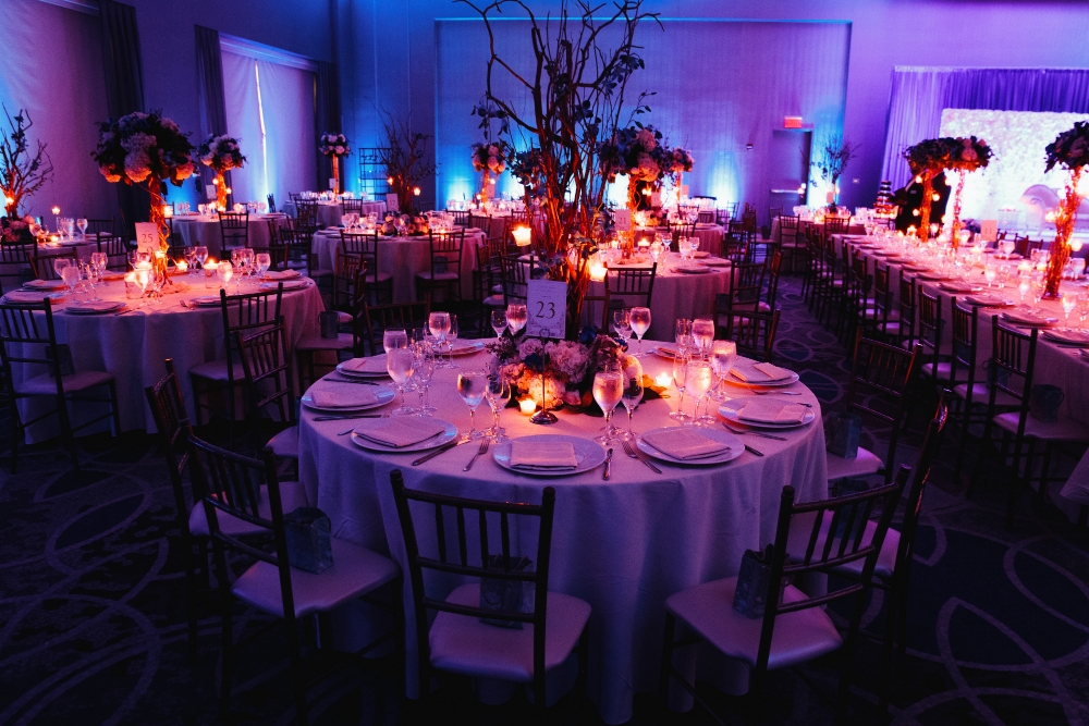 decorated-wedding-hall-with-candles-round-tables-centerpieces(1)